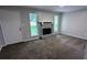 Cozy living room with fireplace, neutral paint, plush carpeting, and bright windows at 3900 Ferncliff Rd, Snellville, GA 30039