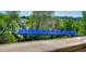 Striking blue bridge surrounded by trees, adding a pop of color to the natural landscape at 470 Ansley Walk Ne Ter, Atlanta, GA 30309