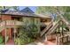 Multi-story home with upper level balconies, brick accents, and stairs to front door at 470 Ansley Walk Ne Ter, Atlanta, GA 30309