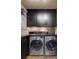 Functional laundry room with ample storage cabinets and modern washer and dryer at 470 Ansley Walk Ne Ter, Atlanta, GA 30309