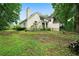 View of a backyard showcasing the home's architectural style and lush green space at 790 Friendship Church Rd, Douglasville, GA 30134