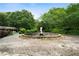 Expansive backyard featuring a circular fountain, mature trees, and lush landscaping at 790 Friendship Church Rd, Douglasville, GA 30134