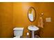 Cozy half bathroom with classic fixtures, oval mirror, and warm color palette provides convenience at 790 Friendship Church Rd, Douglasville, GA 30134