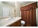Traditional bathroom with a single sink vanity, neutral countertops, and a shower with brown curtains at 790 Friendship Church Rd, Douglasville, GA 30134