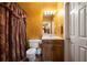 Bathroom features a toilet, sink, mirror with lighting, and a unique decorative curtain adding charm and style at 790 Friendship Church Rd, Douglasville, GA 30134
