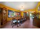 Elegant dining room featuring a large table, chandelier, and unique artwork for sophisticated gatherings at 790 Friendship Church Rd, Douglasville, GA 30134