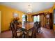 Spacious dining room with grand table, chandelier, and ample natural light creates a warm ambiance at 790 Friendship Church Rd, Douglasville, GA 30134