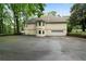 Exterior view of the home with a large driveway and lush green surroundings at 790 Friendship Church Rd, Douglasville, GA 30134