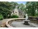 A fountain with stone surround adds character to the front yard of this stately home at 790 Friendship Church Rd, Douglasville, GA 30134