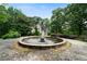 Mature landscaping and trees surround this home with a fountain feature in the front yard at 790 Friendship Church Rd, Douglasville, GA 30134