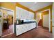 Spacious kitchen with white cabinets and black countertops open to the living area and stairs at 790 Friendship Church Rd, Douglasville, GA 30134