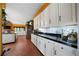 Modern kitchen with white cabinets, black countertops, stainless steel appliances, and tile flooring at 790 Friendship Church Rd, Douglasville, GA 30134