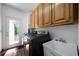 Laundry room with modern washer/dryer and cabinets above sink, showcasing convenience and practicality at 790 Friendship Church Rd, Douglasville, GA 30134