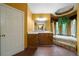 Large main bathroom with garden tub, extended countertop, vanity, and natural light from a window at 790 Friendship Church Rd, Douglasville, GA 30134