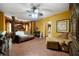Expansive main bedroom with elegant furniture, canopy bed, stylish ceiling fan and tiled floor at 790 Friendship Church Rd, Douglasville, GA 30134