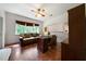 Cozy home office featuring a dark wood desk, matching built-in shelves, and comfortable leather couch at 790 Friendship Church Rd, Douglasville, GA 30134