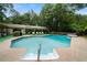 Large private swimming pool with steps, surrounded by lush greenery and a pool house at 790 Friendship Church Rd, Douglasville, GA 30134