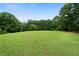A large green backyard with mature trees at 790 Friendship Church Rd, Douglasville, GA 30134