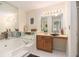 Bathroom with large jacuzzi tub, vanity, mirrors, and overhead lighting at 1272 Whitlock Ridge Drive Sw Dr, Marietta, GA 30064