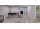 A large basement featuring wood-look floors and a table, with adjacent laundry space at 263 Bennett Farms Trl, Acworth, GA 30102