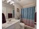 A bathroom featuring a light pink shower curtain and a white vanity with silver fixtures at 263 Bennett Farms Trl, Acworth, GA 30102