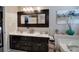 Bathroom vanity features a double-sink, decorative mirror, and tub at 263 Bennett Farms Trl, Acworth, GA 30102