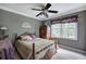 A bedroom with olive colored walls, a ceiling fan, and a wooden bed frame at 263 Bennett Farms Trl, Acworth, GA 30102