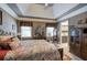 A cozy bedroom with a tray ceiling and an ensuite bath at 263 Bennett Farms Trl, Acworth, GA 30102