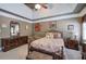 Primary bedroom featuring tray ceiling, comfortable furnishings, and a ceiling fan at 263 Bennett Farms Trl, Acworth, GA 30102