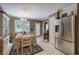Charming dining area with stainless steel refrigerator, chandelier, and a view of the backyard at 263 Bennett Farms Trl, Acworth, GA 30102
