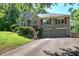 Two-story home with two-car garage, stone accents, red shutters, and lovely landscaping at 263 Bennett Farms Trl, Acworth, GA 30102