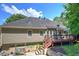 Home exterior features a large deck, well-maintained lawn and concrete patio at 263 Bennett Farms Trl, Acworth, GA 30102