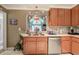 A cozy kitchen featuring warm wood cabinets, stainless steel appliances, and unique stained glass window at 263 Bennett Farms Trl, Acworth, GA 30102
