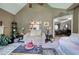 Bright living room with neutral paint, fireplace, plush carpet, and a glimpse into the dining area at 263 Bennett Farms Trl, Acworth, GA 30102