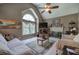 Cozy living room with vaulted ceiling, fireplace, large window, and comfortable seating at 263 Bennett Farms Trl, Acworth, GA 30102