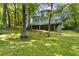 Spacious backyard featuring lush green moss and mature trees at 3902 Robin Court Ct, Acworth, GA 30101