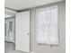 Partially finished basement showcasing a doorway and a window dressed with light sheer curtains at 3902 Robin Court Ct, Acworth, GA 30101