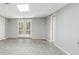 Open basement area with tile flooring, neutral walls, and glass paneled doors to the outside at 3902 Robin Court Ct, Acworth, GA 30101