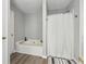Clean and modern bathroom featuring a soaking tub, shower and stylish accents at 3902 Robin Court Ct, Acworth, GA 30101