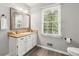 Well-lit bathroom with a vanity, a mirror, and a window that offers plenty of natural light at 3902 Robin Court Ct, Acworth, GA 30101