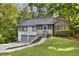 Charming split-level home featuring a two-car garage, screened porch entry, and mature trees at 3902 Robin Court Ct, Acworth, GA 30101