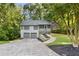 Charming split-level home featuring a two-car garage, screened porch entry, and mature trees at 3902 Robin Court Ct, Acworth, GA 30101