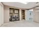 Bright laundry room with modern washer and dryer, cabinets, utility sink, and convenient shelving at 3902 Robin Court Ct, Acworth, GA 30101