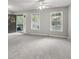 Neutral living room with a ceiling fan, and natural light coming from two large windows at 3902 Robin Court Ct, Acworth, GA 30101