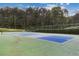 Community tennis court is fenced in surrounded by trees and well-maintained at 3902 Robin Court Ct, Acworth, GA 30101