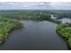 Aerial view showcases the home's waterfront location with lush surrounding trees and lake access at 504 Telfair Park, Peachtree City, GA 30269