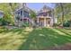 Beautiful backyard featuring tiered decks and lush green lawn perfect for outdoor entertaining at 504 Telfair Park, Peachtree City, GA 30269