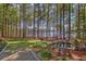 Serene backyard oasis with a picturesque pond, bench, and lush greenery overlooking the lake at 504 Telfair Park, Peachtree City, GA 30269