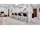 Basement bar area with seating, stairs and a door at 504 Telfair Park, Peachtree City, GA 30269