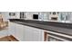 Wet bar features white cabinets, dark countertops, and stainless steel beverage fridge at 504 Telfair Park, Peachtree City, GA 30269